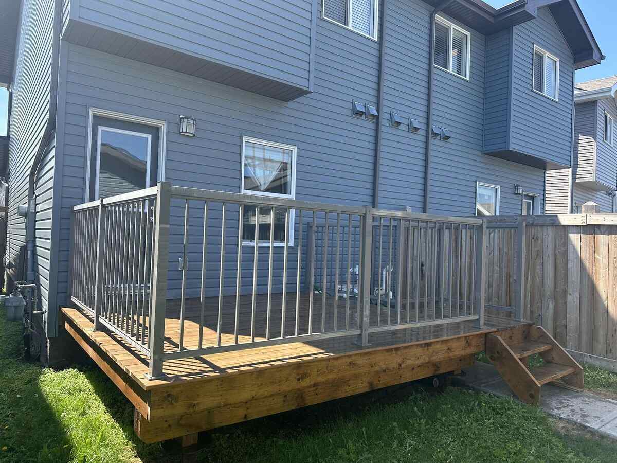 Custom deck with metal railing Edmonton — TrueBlue Builders Ltd